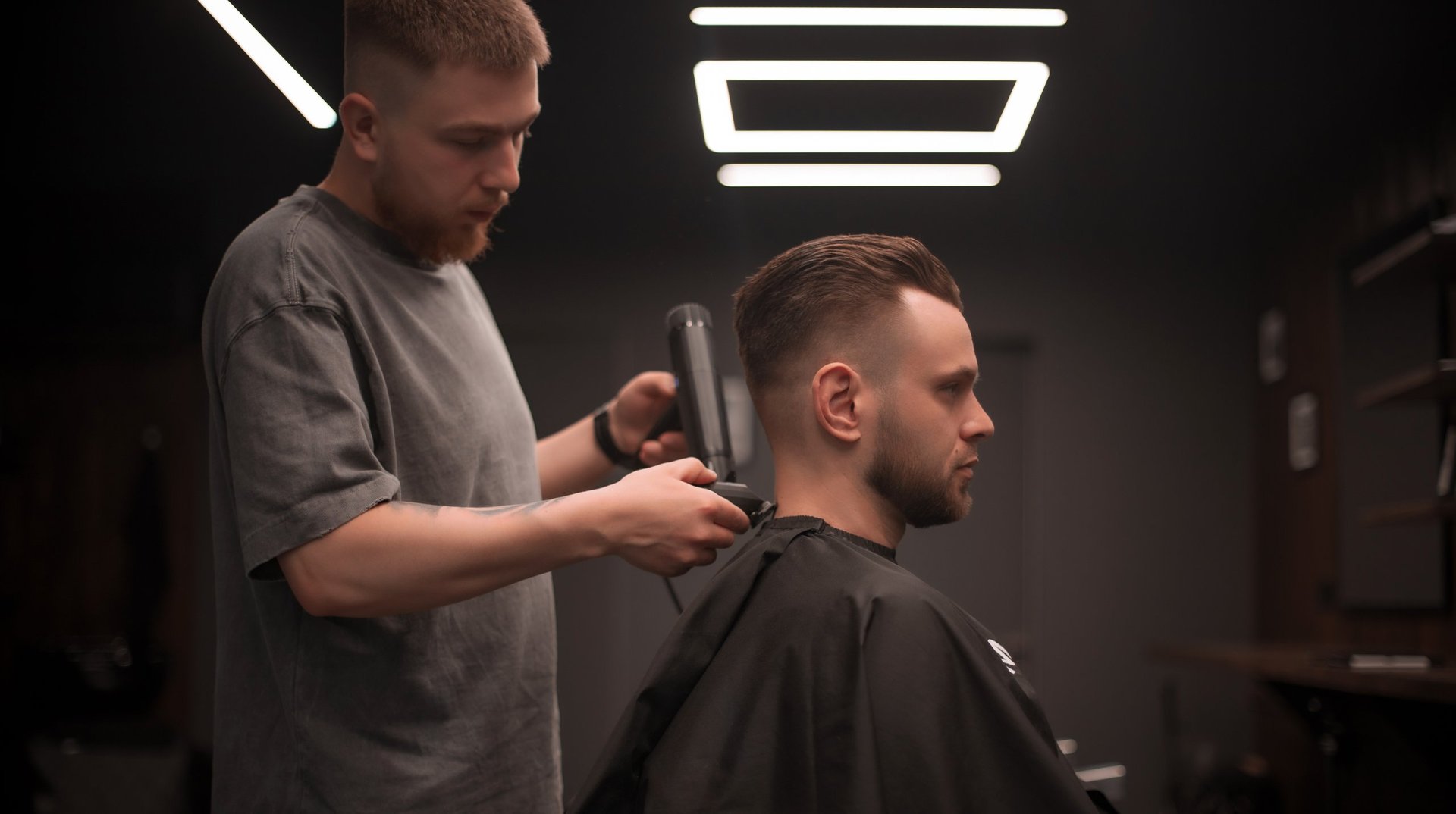 Premium barber styling hair in modern barbershop